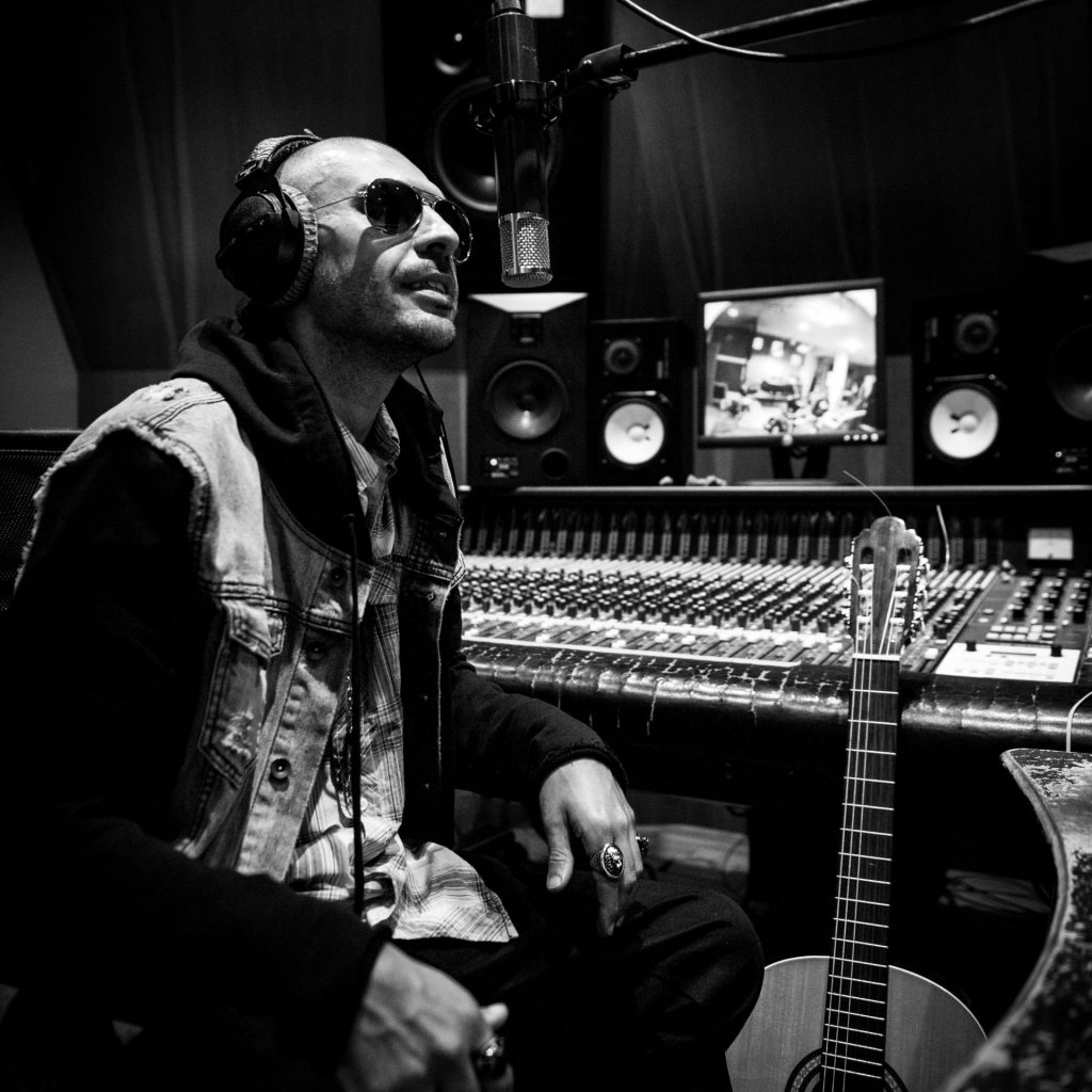 a man sitting in a recording studio with headphones on